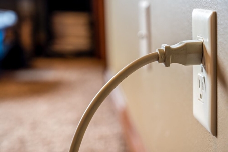 A plug connected to a wall outlet.