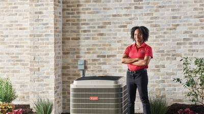 Staff beside an AC unit Photo