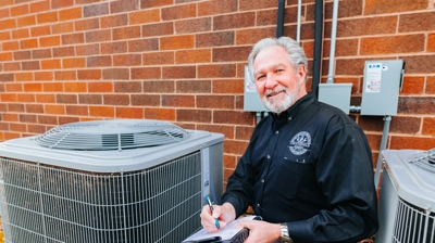 Man beside an AC unit Photo